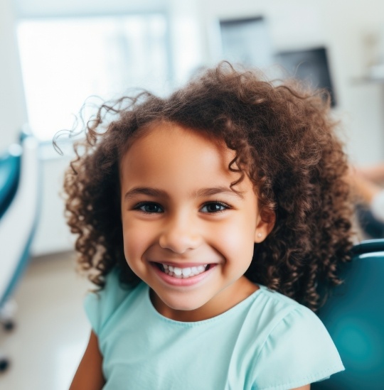 Young girl grinning while visiting dentist for children in Hinsdale and Downers Grove