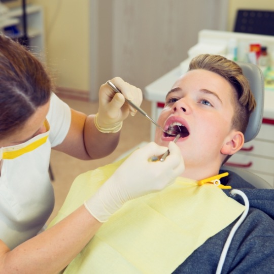 Teenage boy receiving a dental checkup