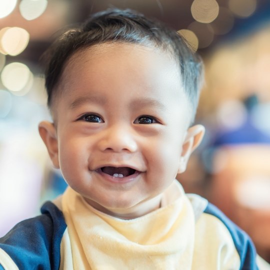 Smiling toddler with only two lower teeth