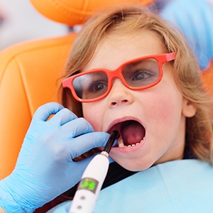 a child getting a dental filling from a pediatric dentist