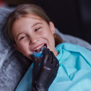 A child being fitted for a customized mouthguard