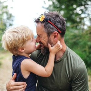 A father and sun walking on a trail together