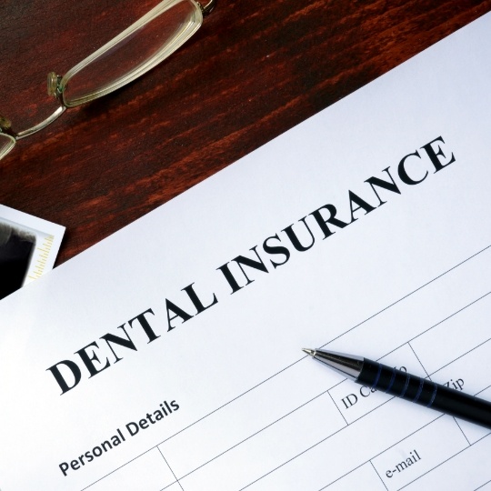 Dental insurance paperwork on table