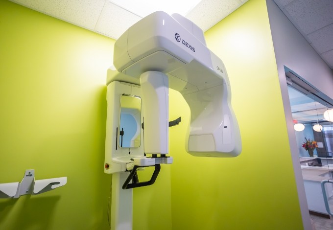 Green hallway branching off into dental treatment rooms